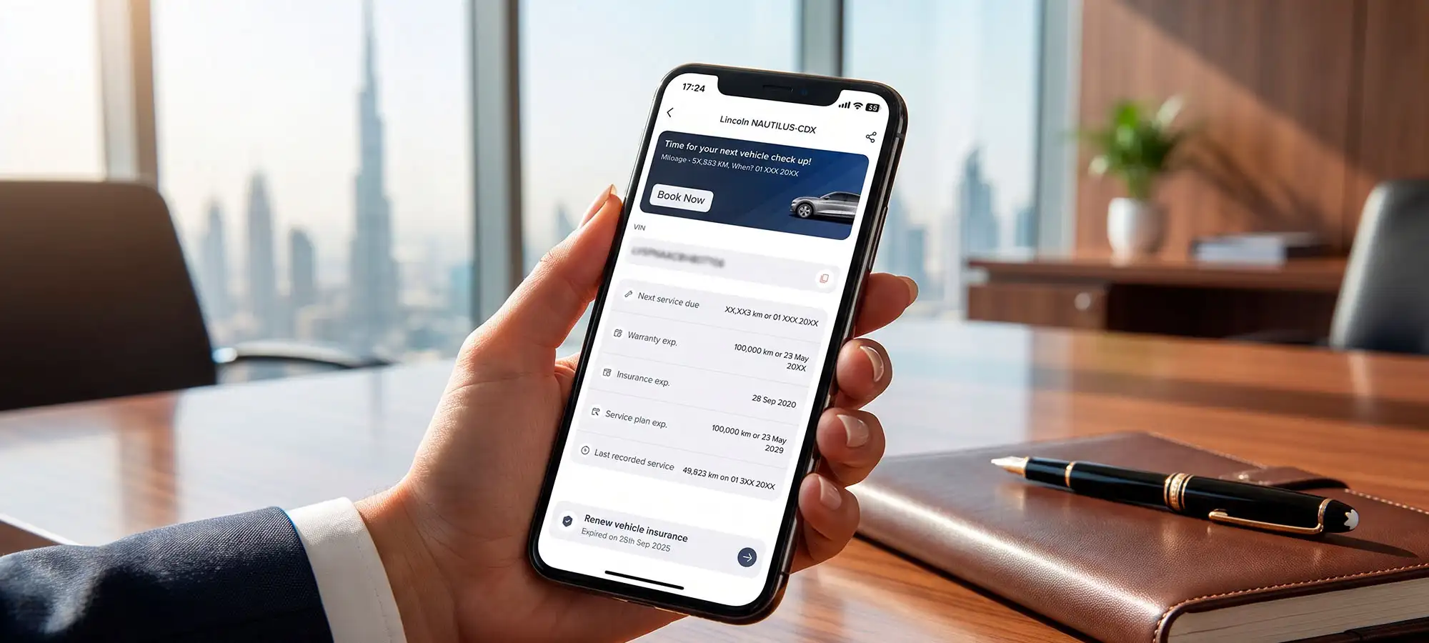Hand holding a phone showing used car warranty details and service contact information
