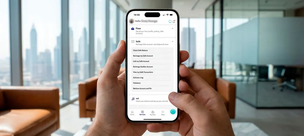 Driver using the RTA Dubai app on a smartphone to check and recharge their Salik balance