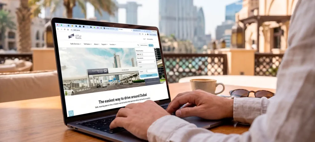 Man using a laptop to perform a salik balance check through the official Salik website